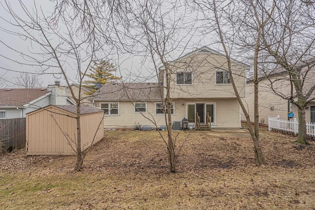 back of house featuring a storage shed, central AC unit, and a patio area