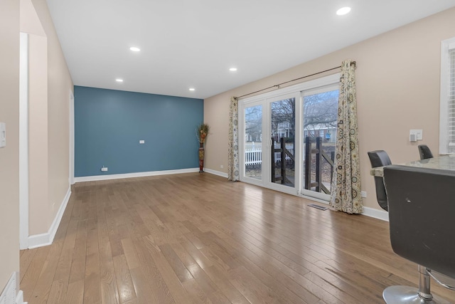 unfurnished office with light wood-type flooring