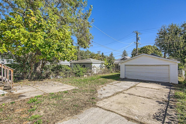 view of yard with a garage and an outdoor structure