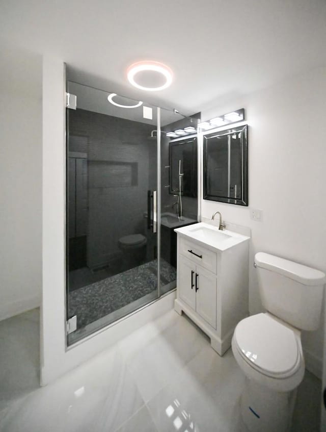 bathroom featuring an enclosed shower, vanity, and toilet