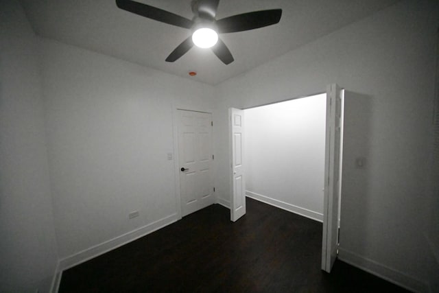 unfurnished room featuring ceiling fan and dark hardwood / wood-style flooring