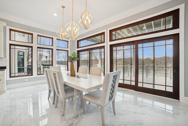 dining area featuring a notable chandelier and ornamental molding