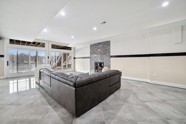 living room featuring a large fireplace