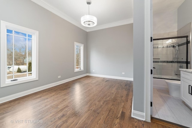 empty room featuring crown molding, a wealth of natural light, and dark hardwood / wood-style flooring