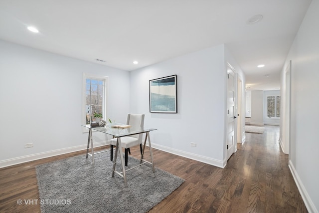 home office with dark hardwood / wood-style floors