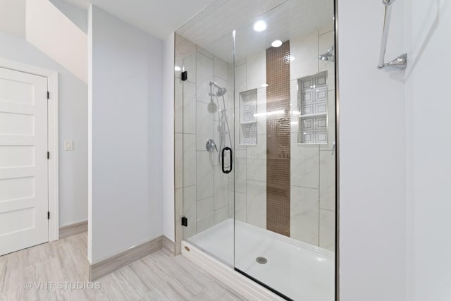 bathroom with wood-type flooring and walk in shower