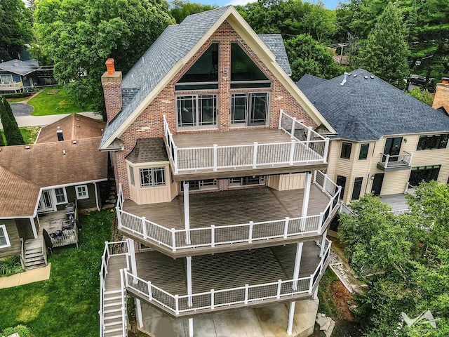 back of property featuring a balcony and a deck