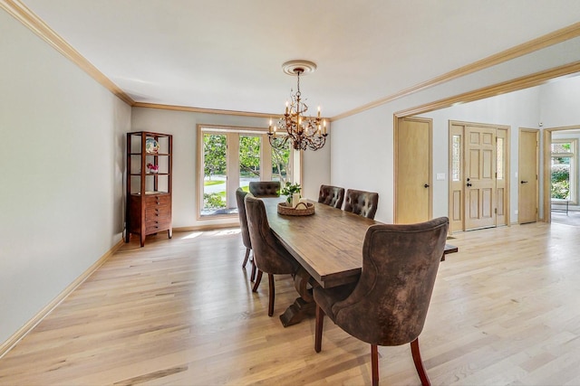 dining room with a wealth of natural light, light hardwood / wood-style flooring, and ornamental molding