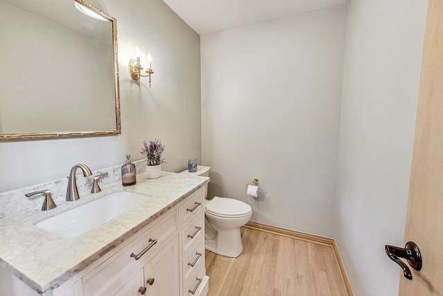 bathroom with vanity, hardwood / wood-style floors, and toilet