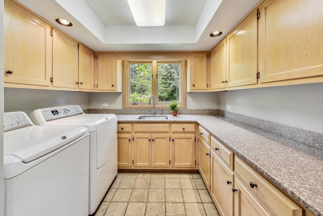 laundry area with cabinets, sink, and washing machine and clothes dryer