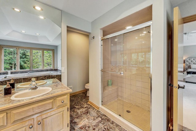 full bathroom with vanity, toilet, independent shower and bath, and a tray ceiling