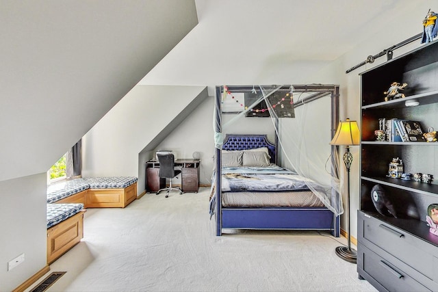 bedroom with lofted ceiling and light carpet