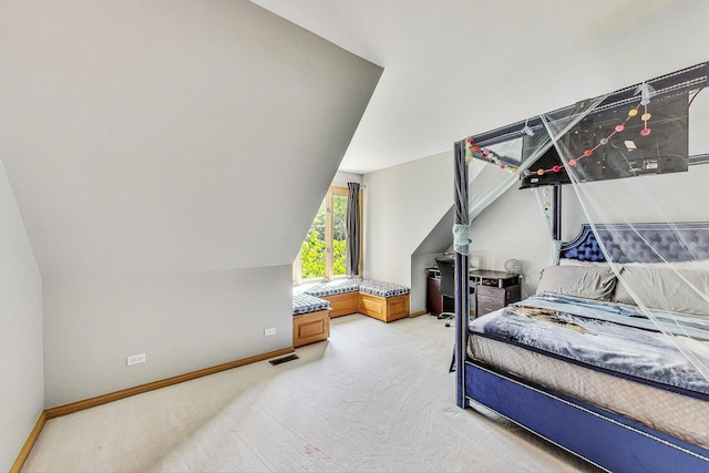 bedroom featuring lofted ceiling and carpet