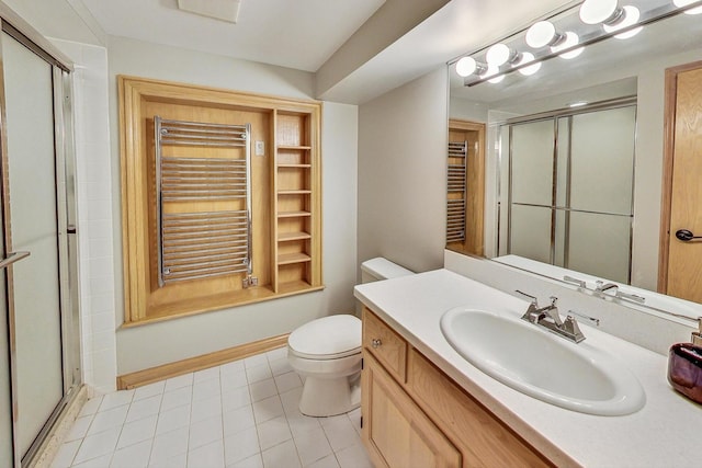 bathroom featuring radiator heating unit, toilet, a shower with shower door, and vanity