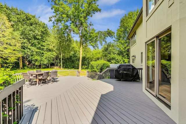 wooden deck with a grill