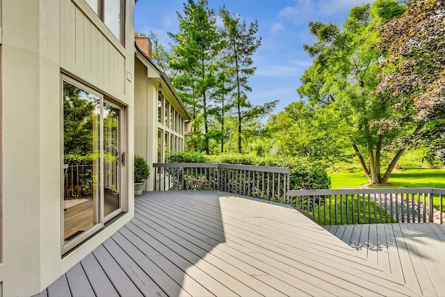 wooden deck featuring a yard