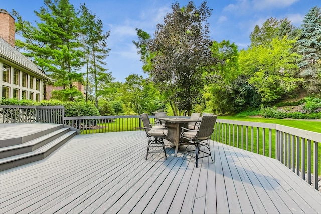 wooden terrace featuring a lawn