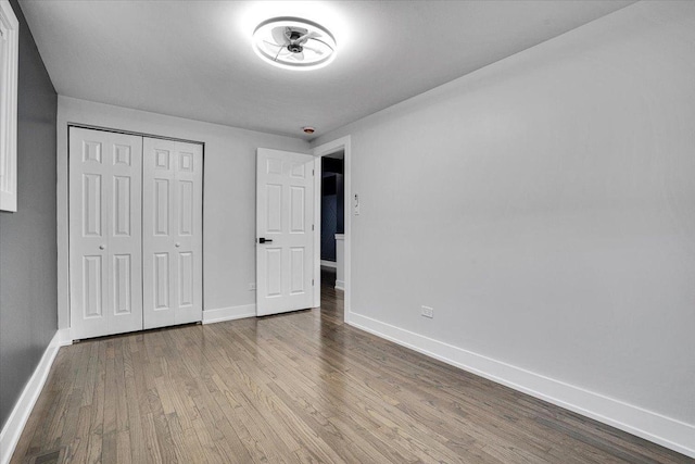 unfurnished bedroom with light hardwood / wood-style floors and a closet