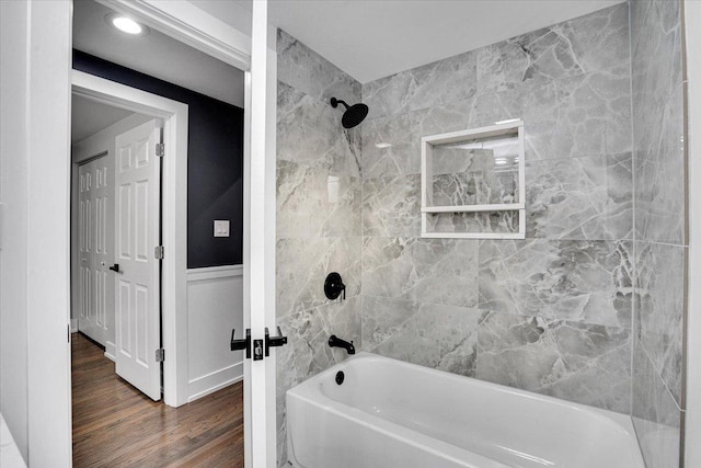 bathroom featuring hardwood / wood-style flooring and tiled shower / bath