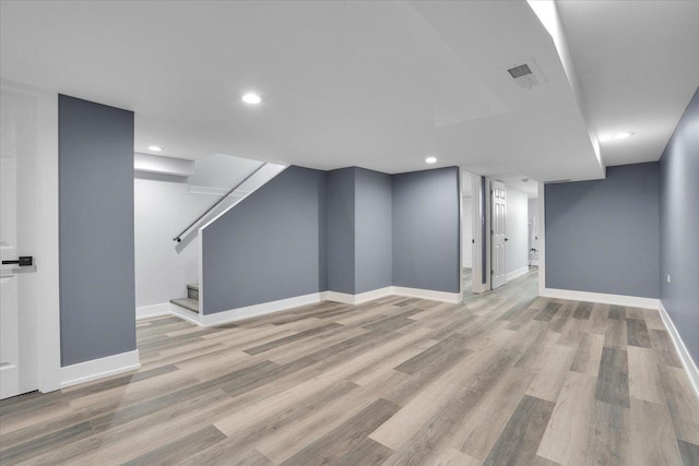 basement featuring light hardwood / wood-style floors