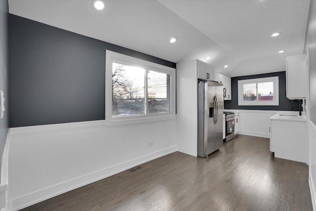 kitchen featuring sink, white cabinetry, vaulted ceiling, appliances with stainless steel finishes, and dark hardwood / wood-style floors