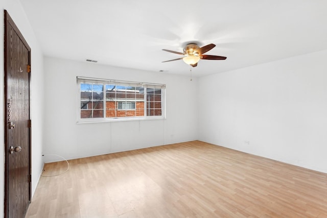 spare room featuring ceiling fan and light hardwood / wood-style flooring