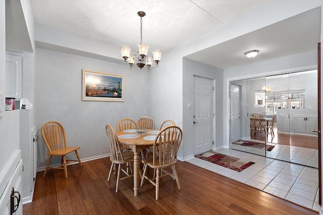 dining area featuring a chandelier and hardwood / wood-style floors