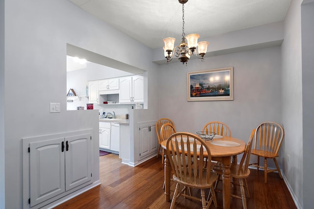 dining area with dark hardwood / wood-style flooring and a notable chandelier