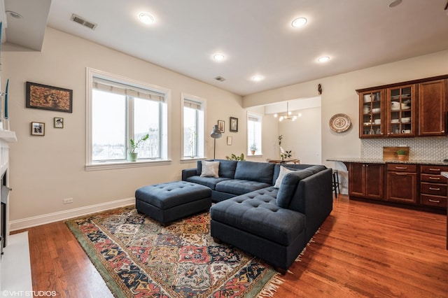 living room with hardwood / wood-style floors and a chandelier