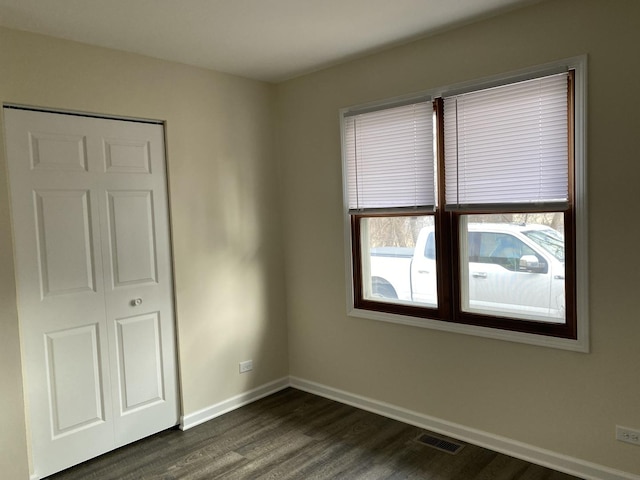 unfurnished bedroom featuring dark wood-type flooring