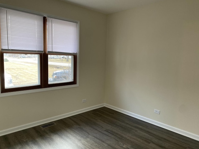 empty room featuring dark wood-type flooring