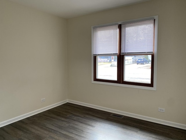 spare room with dark hardwood / wood-style floors