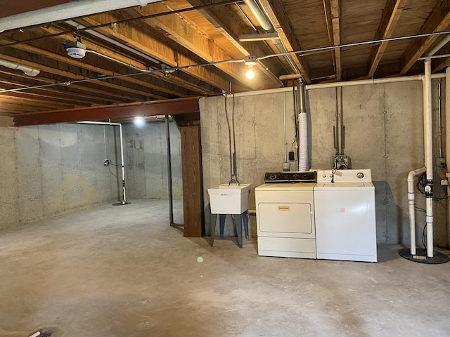 basement featuring separate washer and dryer and sink