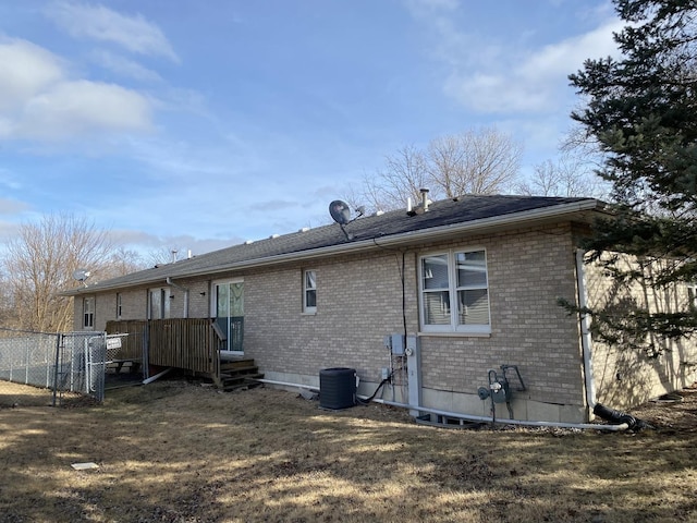 back of property with a yard and cooling unit