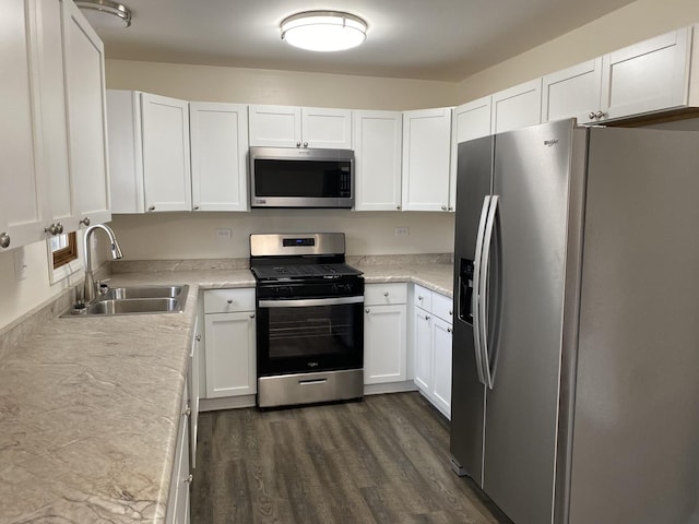 kitchen featuring white cabinetry, sink, stainless steel appliances, and dark hardwood / wood-style floors