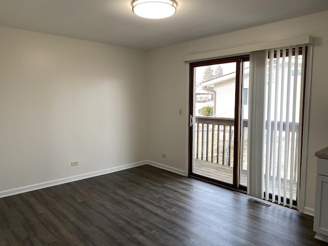 spare room with dark hardwood / wood-style flooring