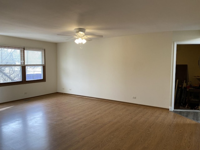 empty room featuring ceiling fan and hardwood / wood-style floors