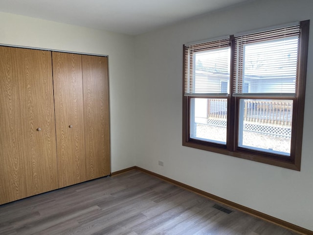 unfurnished bedroom featuring a closet and light wood-type flooring