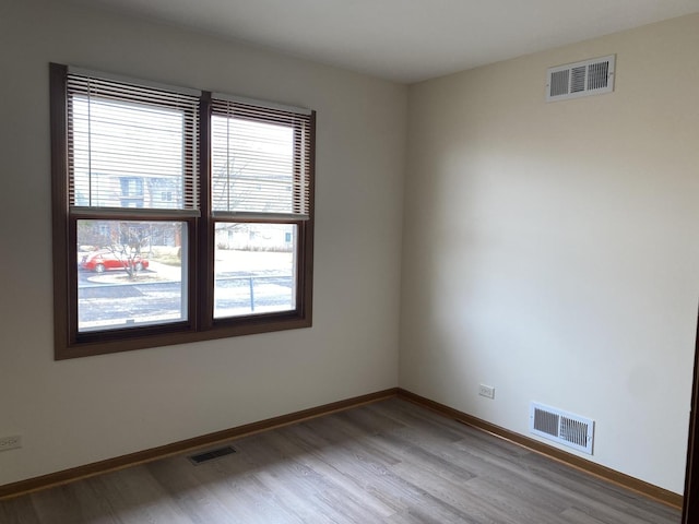 empty room with hardwood / wood-style flooring