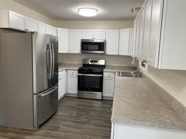 kitchen featuring white cabinetry, sink, dark hardwood / wood-style floors, and appliances with stainless steel finishes