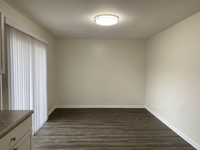 unfurnished room with dark hardwood / wood-style flooring