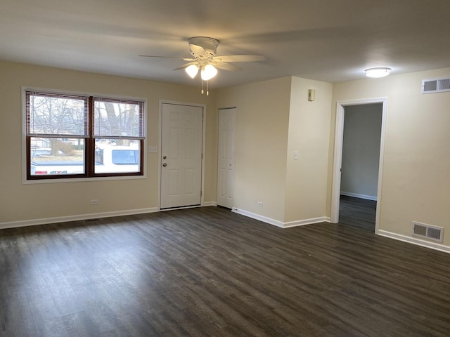 empty room featuring ceiling fan and dark hardwood / wood-style flooring