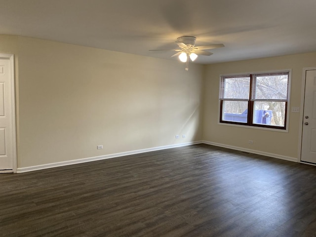 spare room featuring dark wood-type flooring and ceiling fan