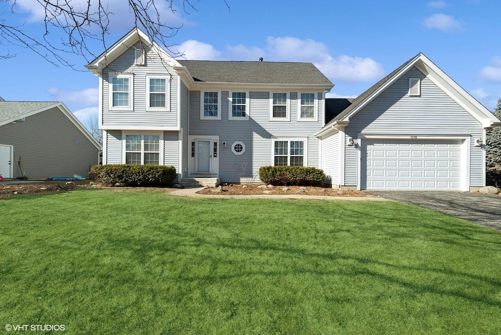 view of front of home with a garage and a front yard