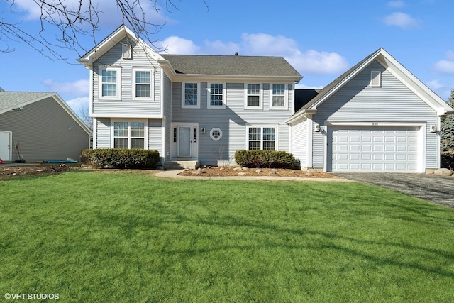 view of front of home with a garage and a front yard