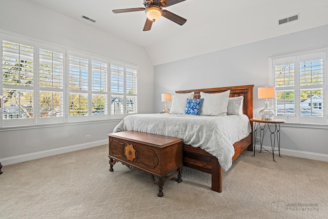 bedroom featuring light carpet, lofted ceiling, and ceiling fan