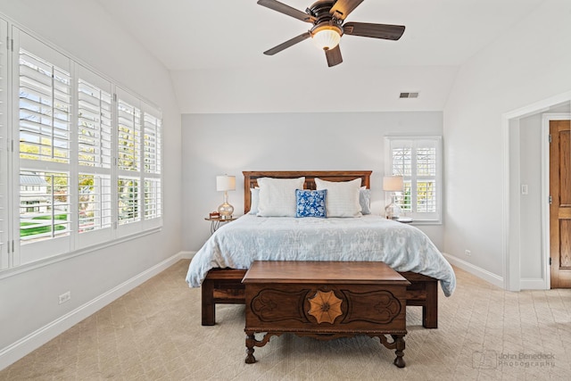 bedroom featuring ceiling fan, lofted ceiling, and light carpet