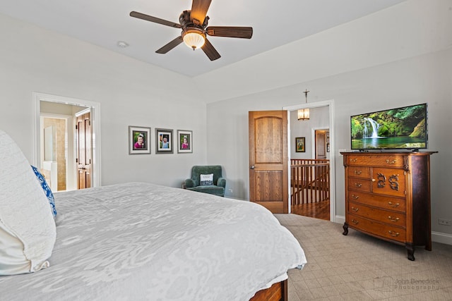 bedroom with ceiling fan, vaulted ceiling, and light carpet