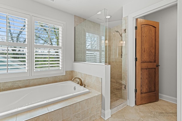 bathroom with shower with separate bathtub and tile patterned floors