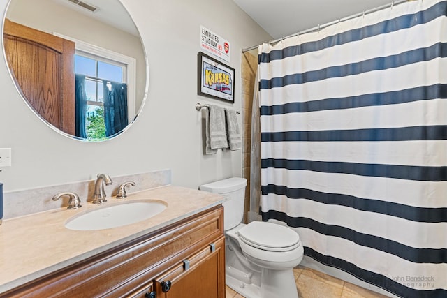 bathroom featuring tile patterned flooring, vanity, a shower with curtain, and toilet